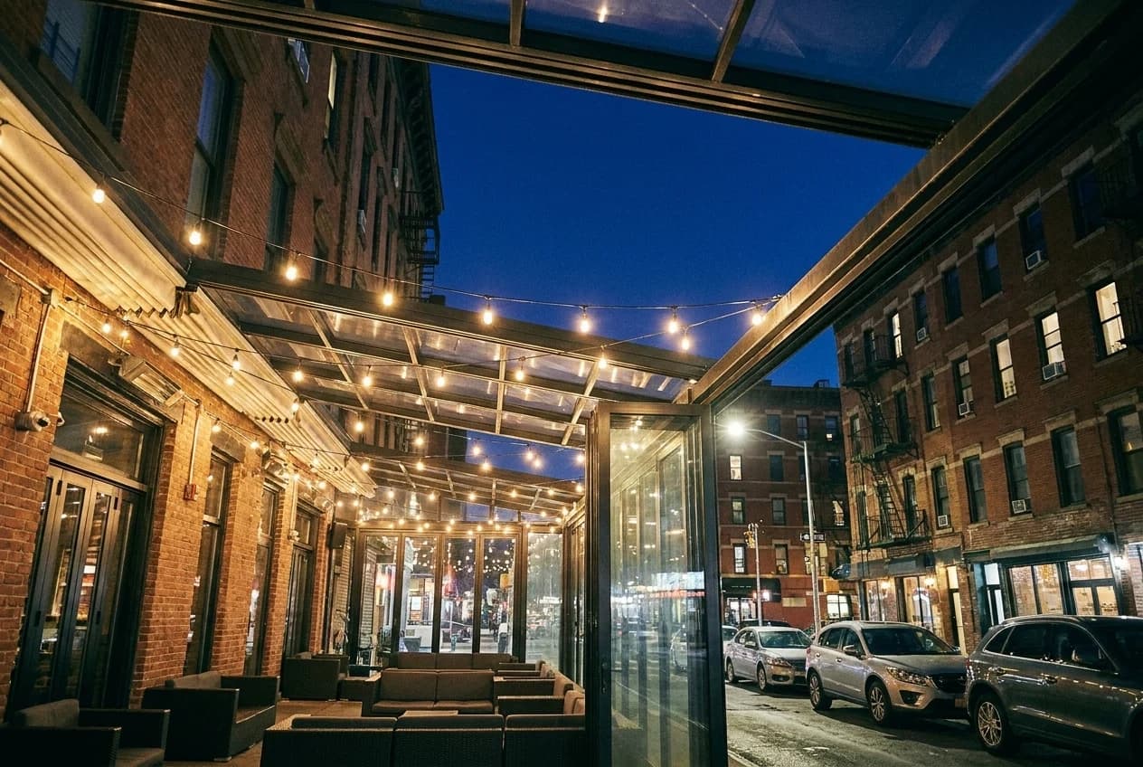 Retractable rooftop lounge at The Delancey before opening, glass panels and string lights overhead