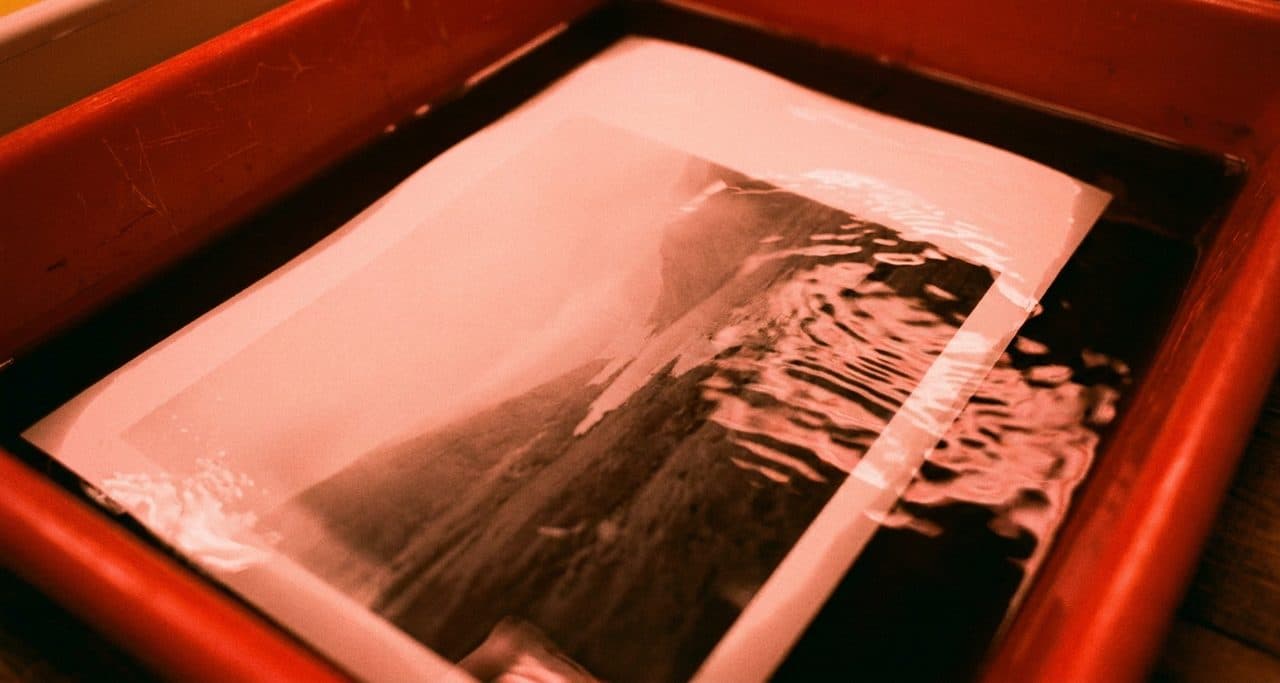A Community Darkroom Where Prints Dry on the Line and Fixer Smell Fills the Air - scene