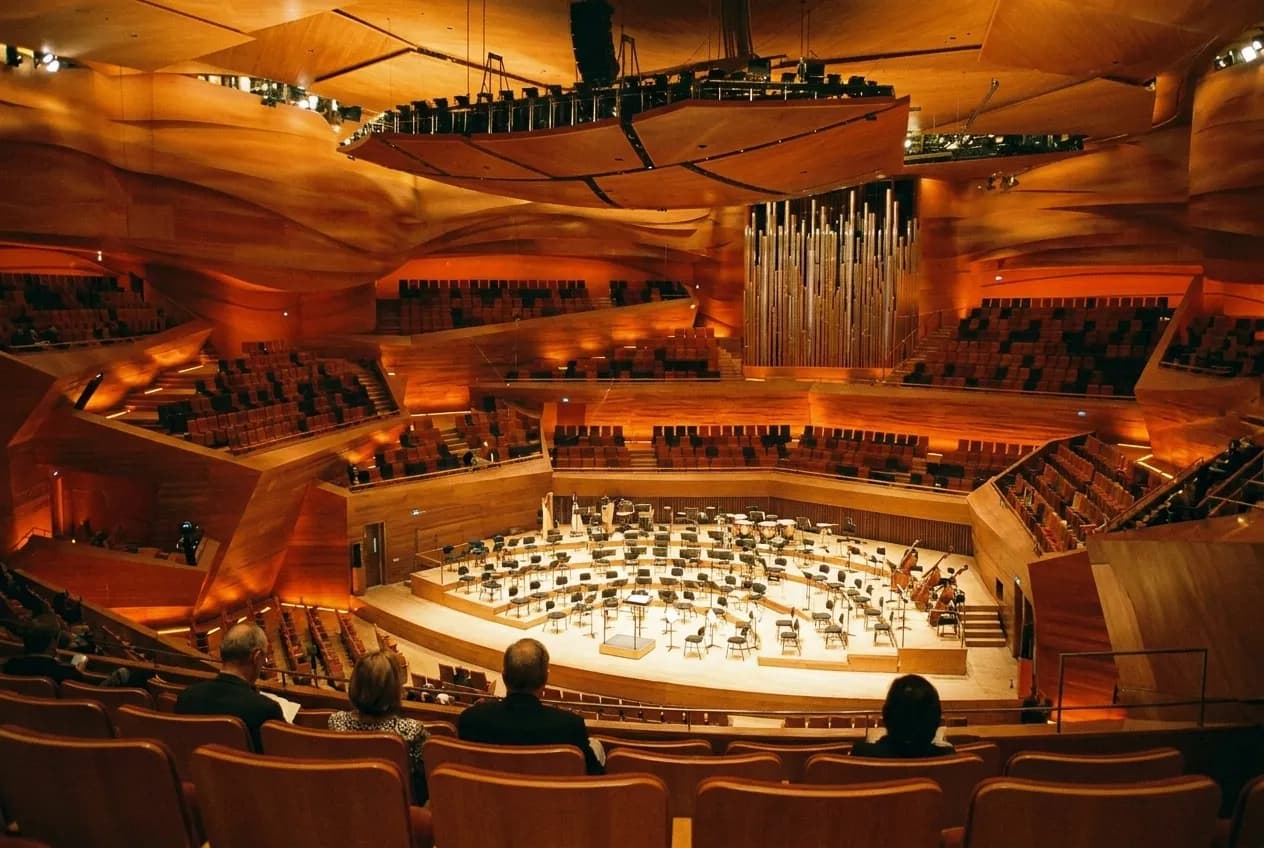 The interior of a modern concert hall seen from the upper seating