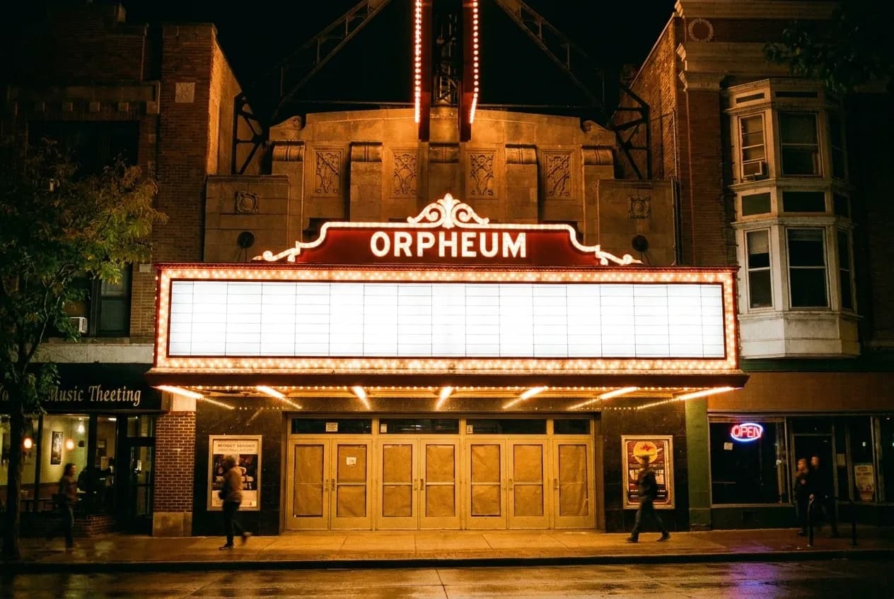 The lit marquee and entrance of a small music venue on a city street at night