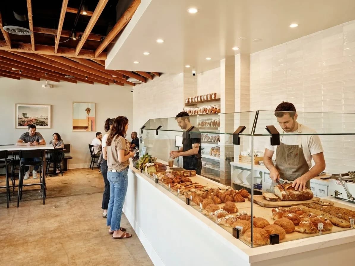 Bakery counter with loaves and pastries in a bright Culver City shop