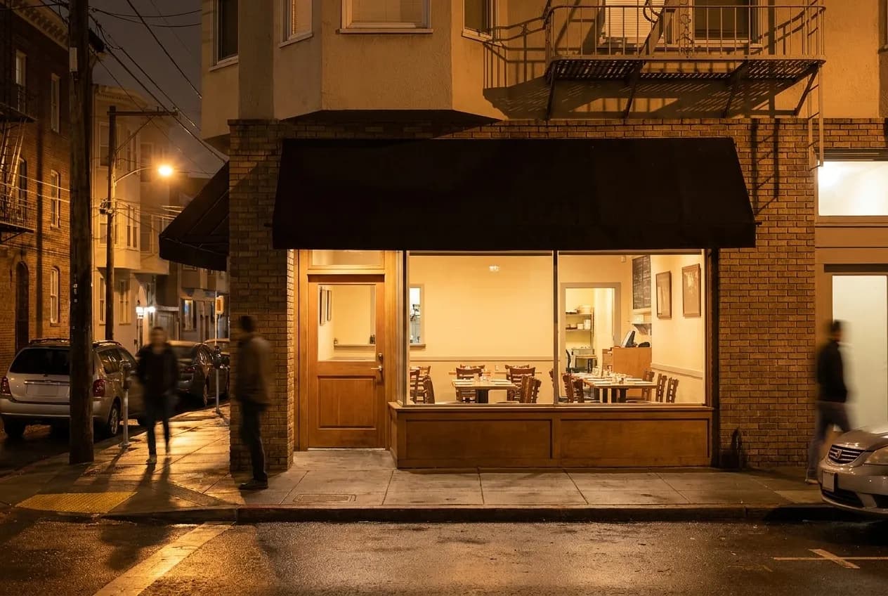 A neighbourhood restaurant frontage at night on a quiet street