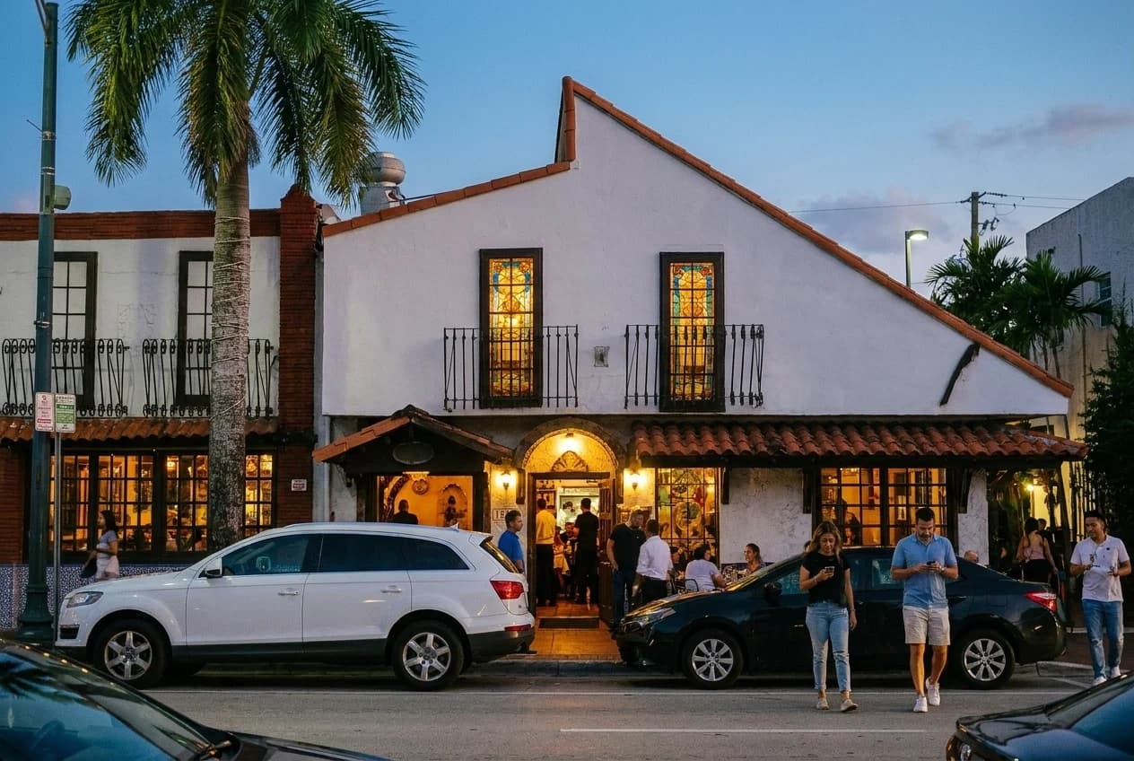Casa Juancho Spanish restaurant facade with stained glass on SW 8th Street at dusk