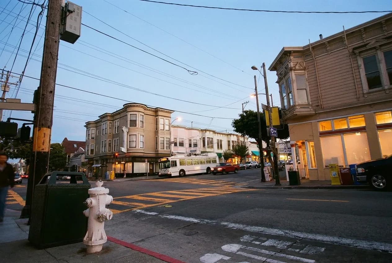 A neighbourhood shopping street in San Francisco in evening light with low storefronts