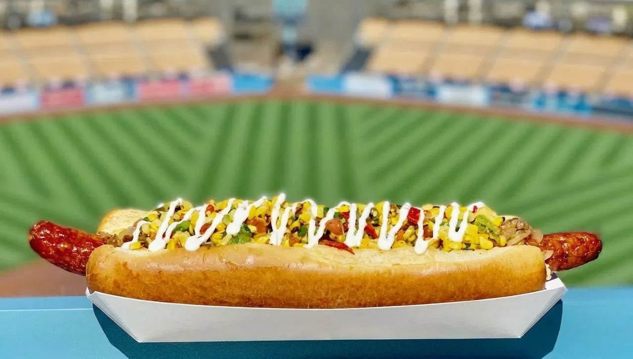 A classic Dodger Dog with the stadium blurred behind it