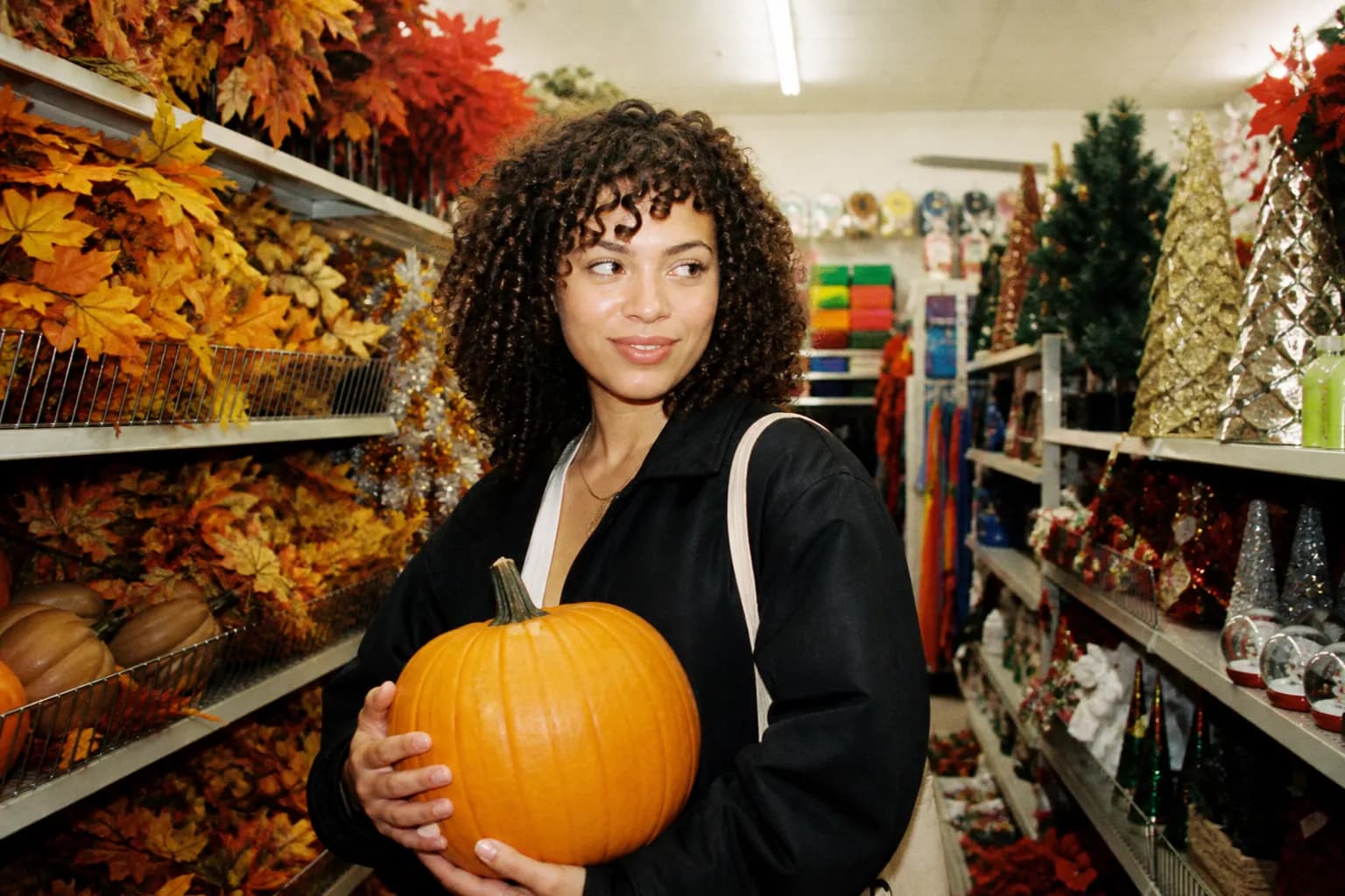 A discount store aisle decorated with seasonal decorations and festive displays
