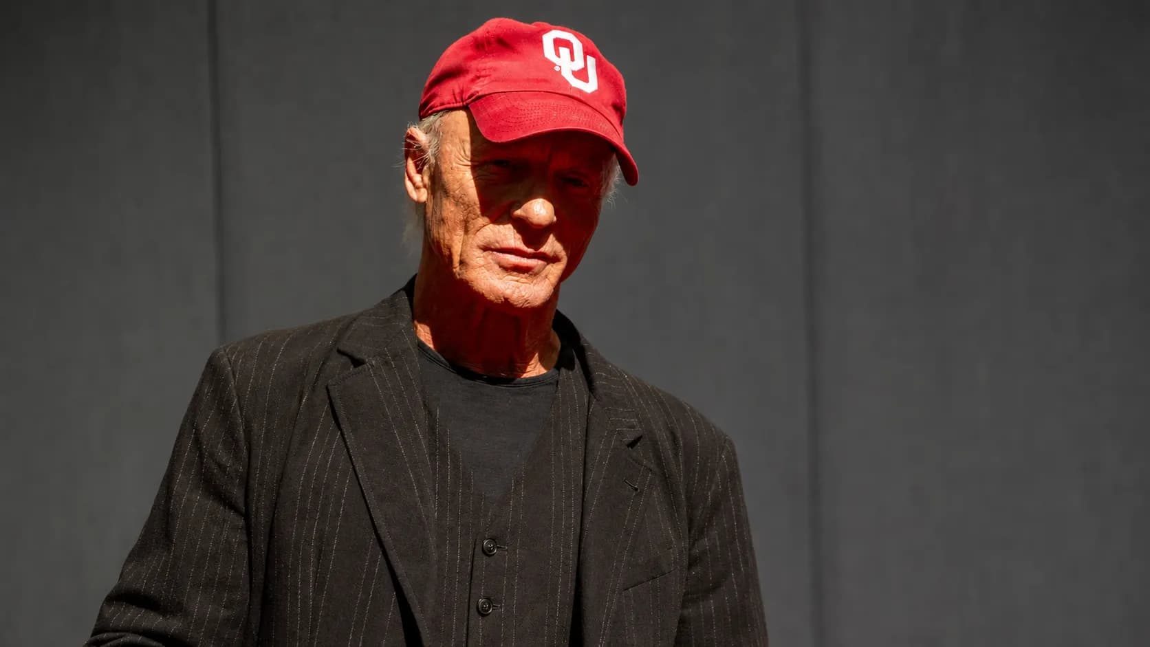 Photorealistic editorial portrait of actor Ed Harris against a neutral background.