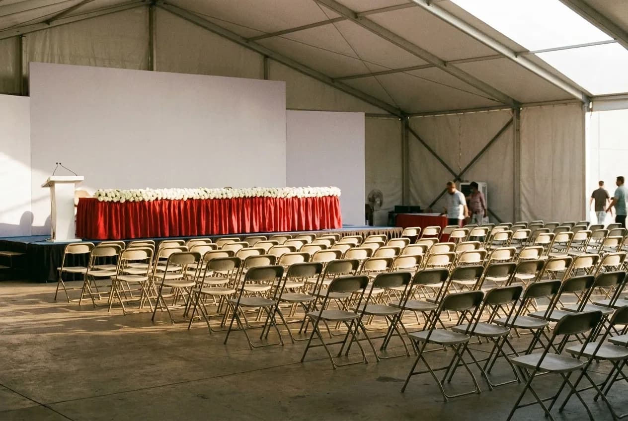 A wide open warehouse event space in Los Angeles set with folding chairs and afternoon light