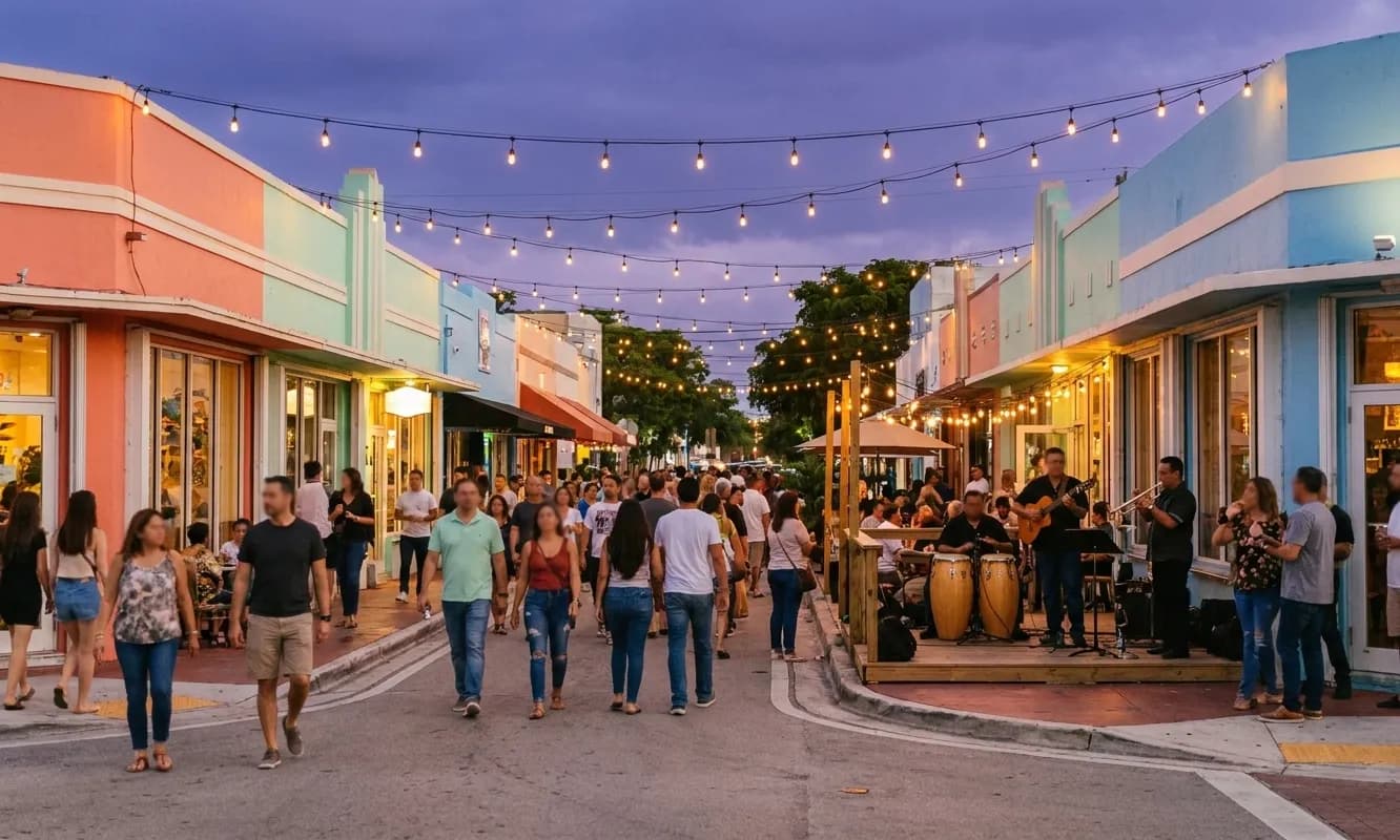 A closed-off Little Havana street on a Friday evening, people walking between low pastel storefronts with a small band on a corner platform under strings of bulbs