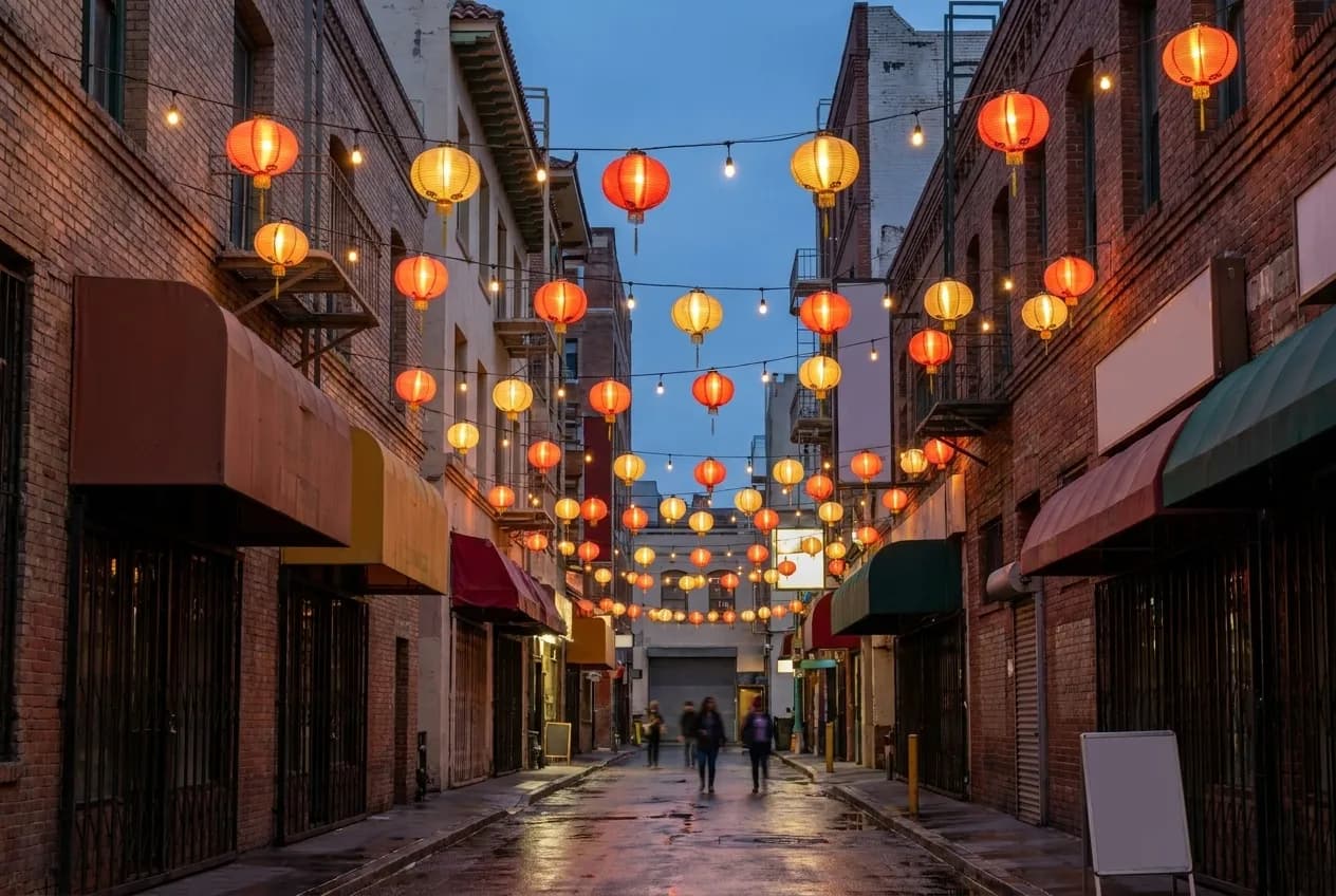 Paper lanterns strung above a narrow shopping street