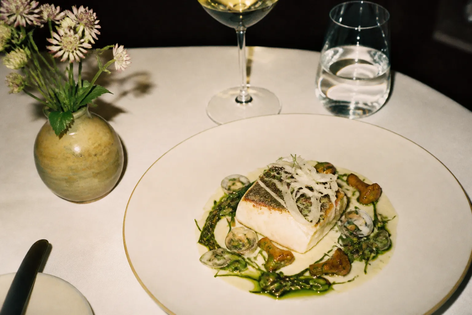 An elegant plated fine-dining dish on a white tablecloth