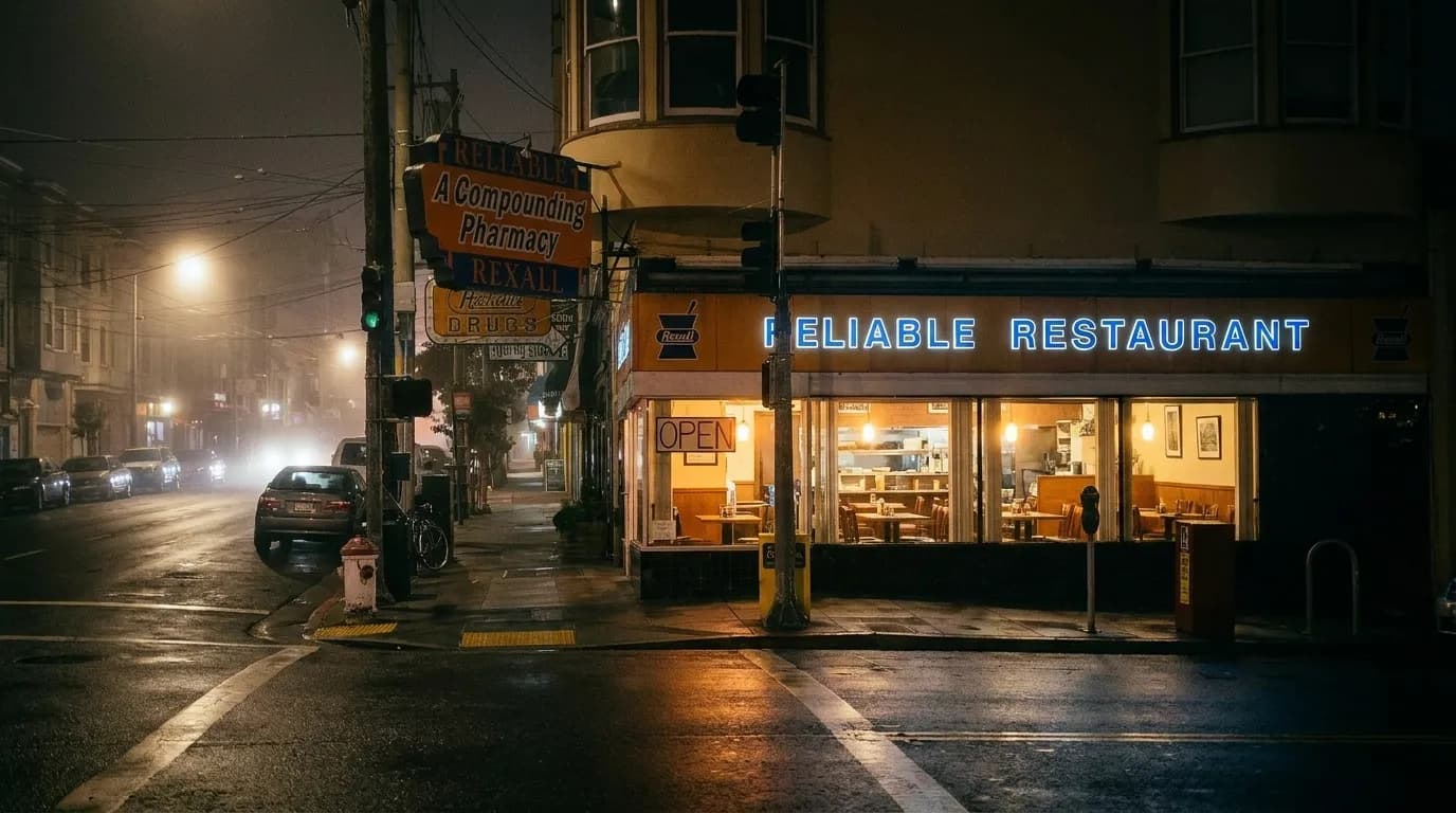 A small San Francisco restaurant lit from inside on a dark residential street at night, fogged windows, a hand-lettered open sign and wet pavement reflecting the light