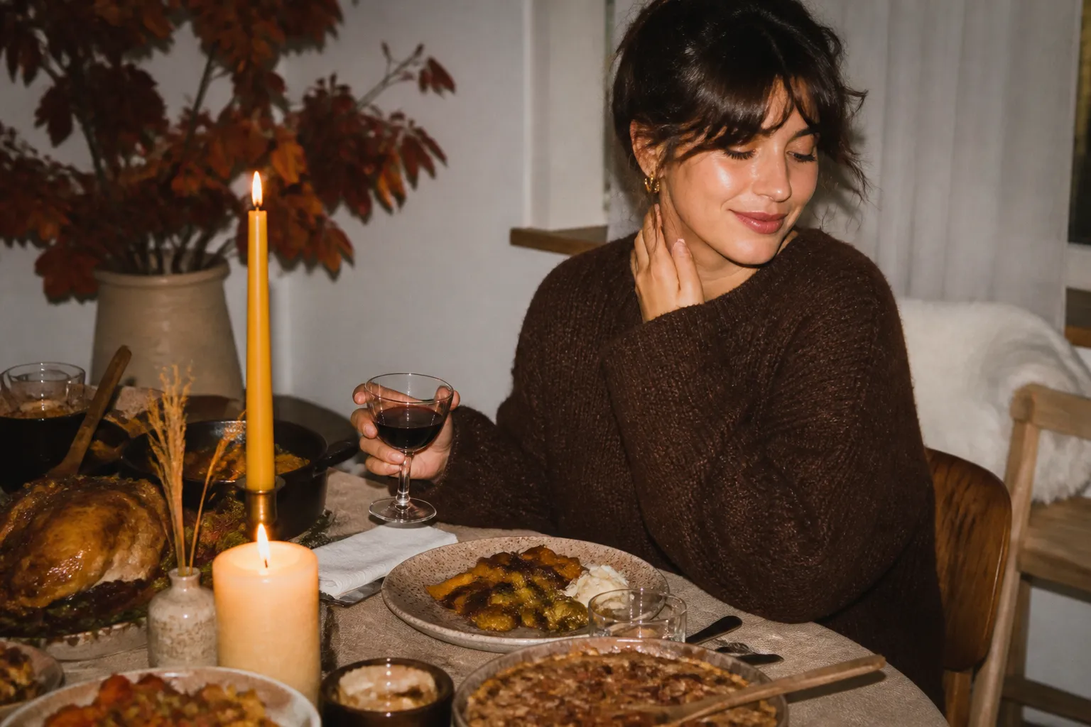 A cozy autumn table setting with warm dishes and candles