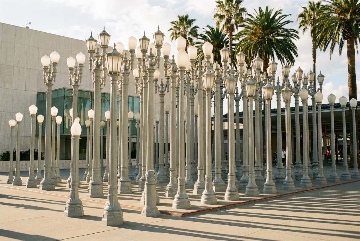 Rows of tall vintage street lamps standing in a museum plaza
