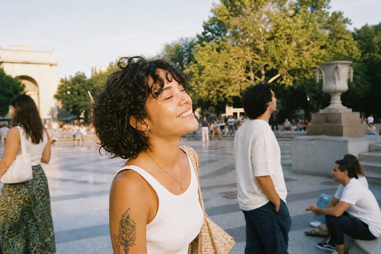 People relaxing and walking through a lively free public plaza