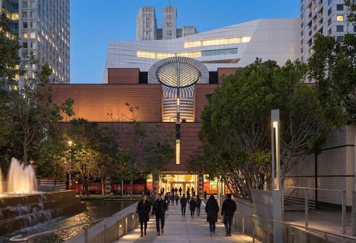 SFMOMA exterior in San Francisco at dusk with pedestrians on the plaza