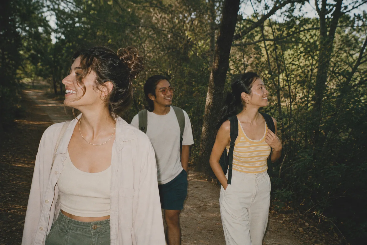 People walking along a free public nature trail lined with trees