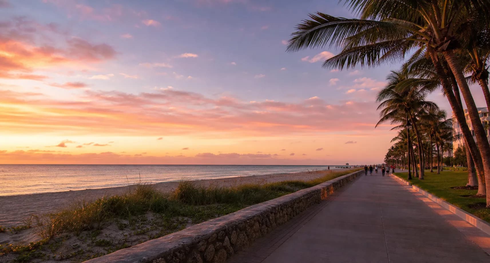 Wide Miami Beach boardwalk at sunset with ocean, palms, and pastel sky