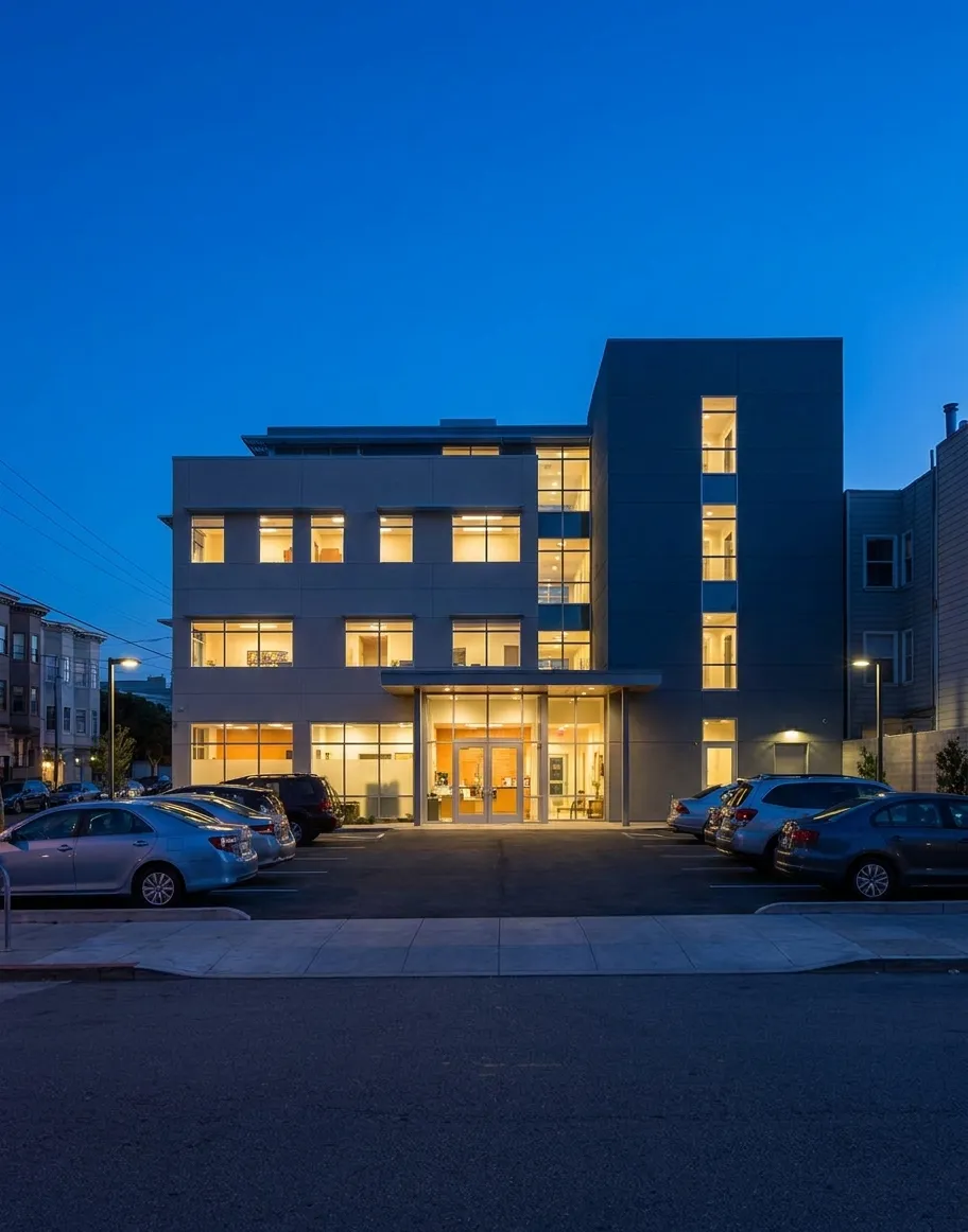 Modern veterinary hospital building on Alabama Street in San Francisco's Mission District at dusk, with illuminated entrance and parking lot visible