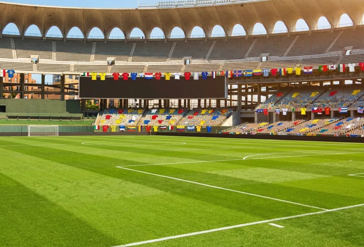 A pristine emerald natural-grass pitch inside MetLife Stadium under bright even light, empty seats rising in tiers, clean lines evoking the 2026 World Cup Final atmosphere