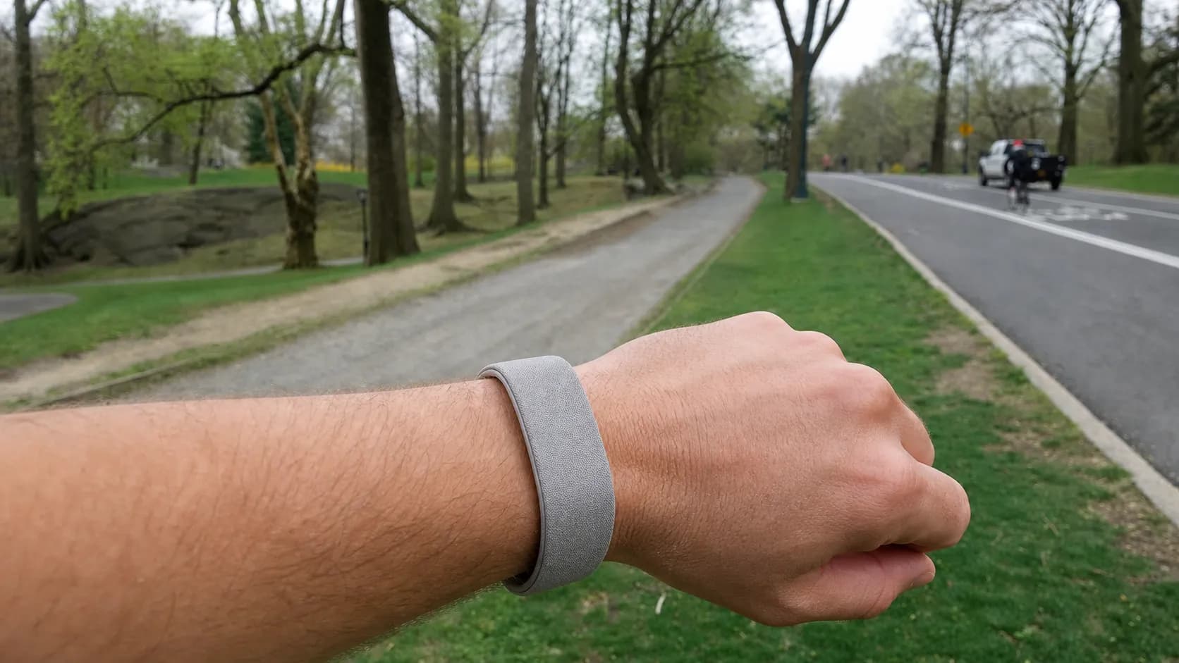A runner in Central Park wearing a discreet screenless fitness band on a morning route.