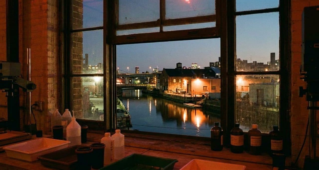 A Gowanus Darkroom Where Red Light and Fixer Smell Fill the Industrial Building - scene