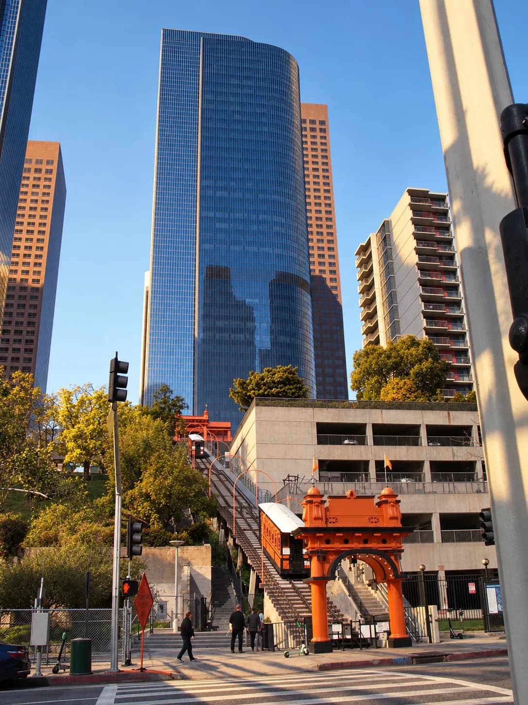 Short orange funicular railway climbing a steep bank between downtown buildings, twin tracks running up to an ornate upper station house