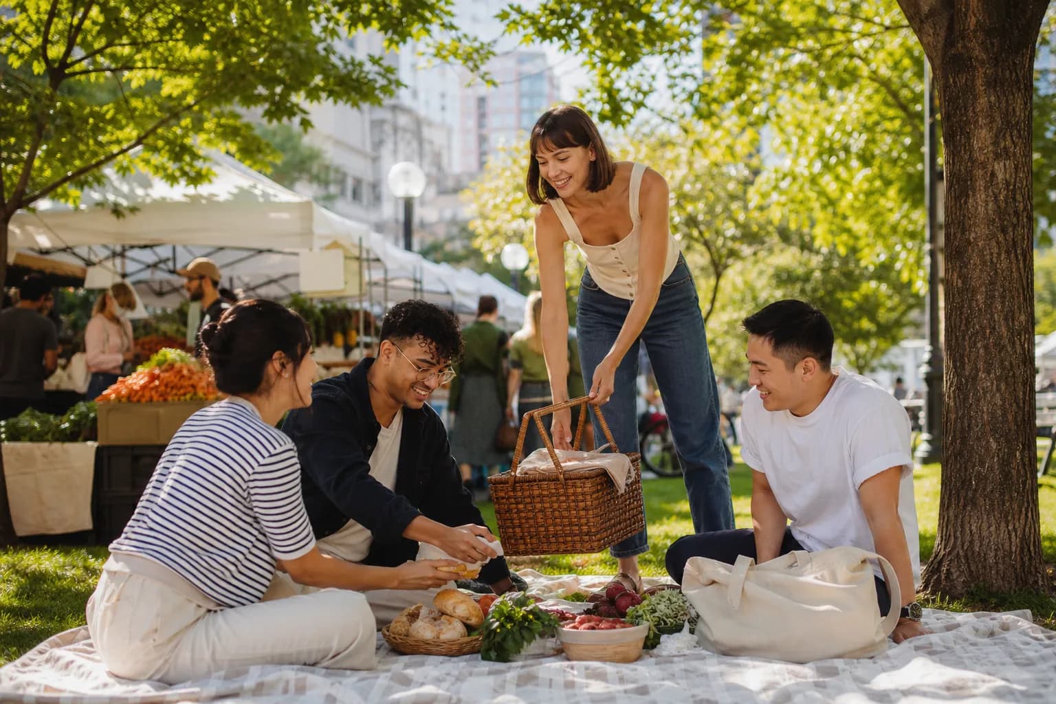 Friends assembling a small park picnic near a farmers market