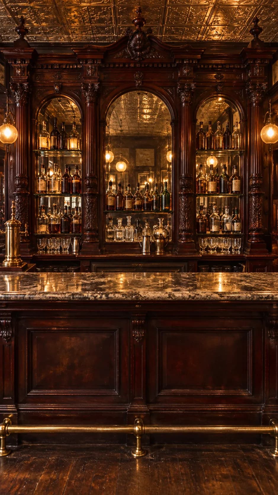 An ornate Victorian bar back with carved wood, mirrors and a marble counter