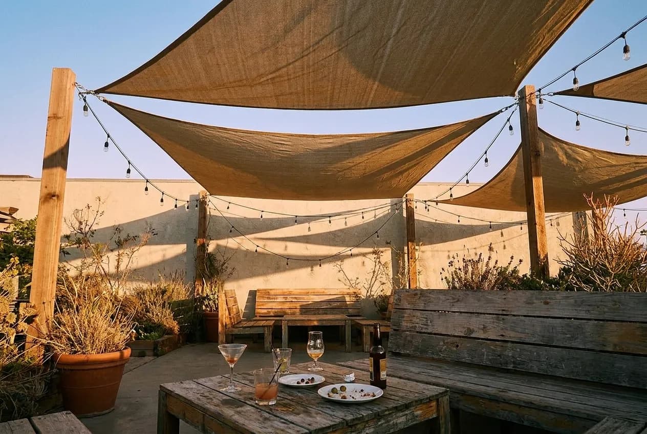 An empty bar patio in Los Angeles under shade sails in the last of the afternoon light