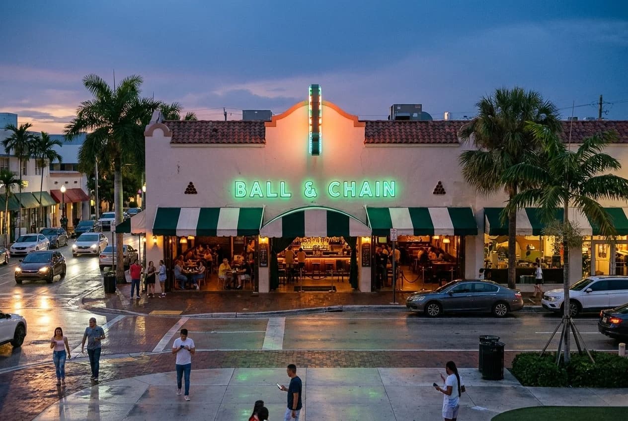 Outdoor patio tables on Southwest 8th Street in Little Havana during late afternoon with rooster statue visible