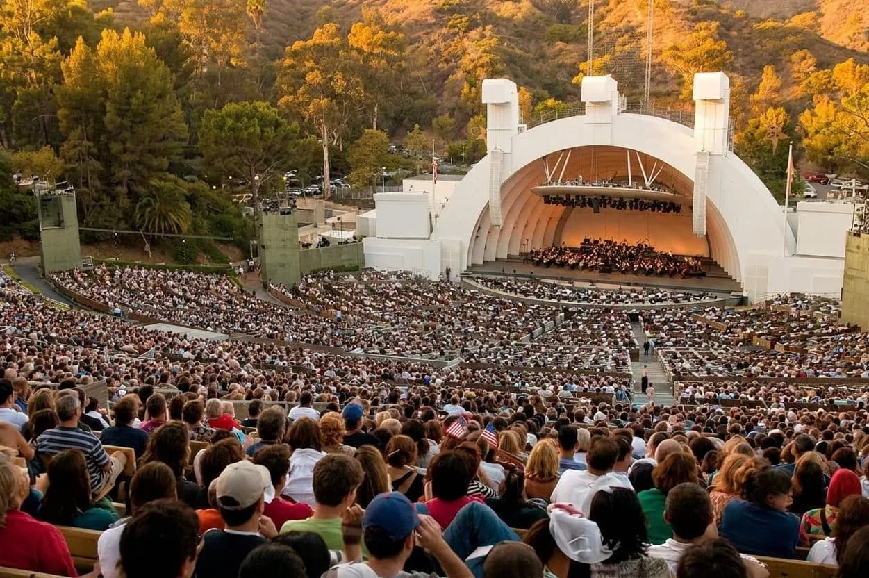 Hollywood Bowl amphitheater at golden hour with tiered seating and the shell framed by hills