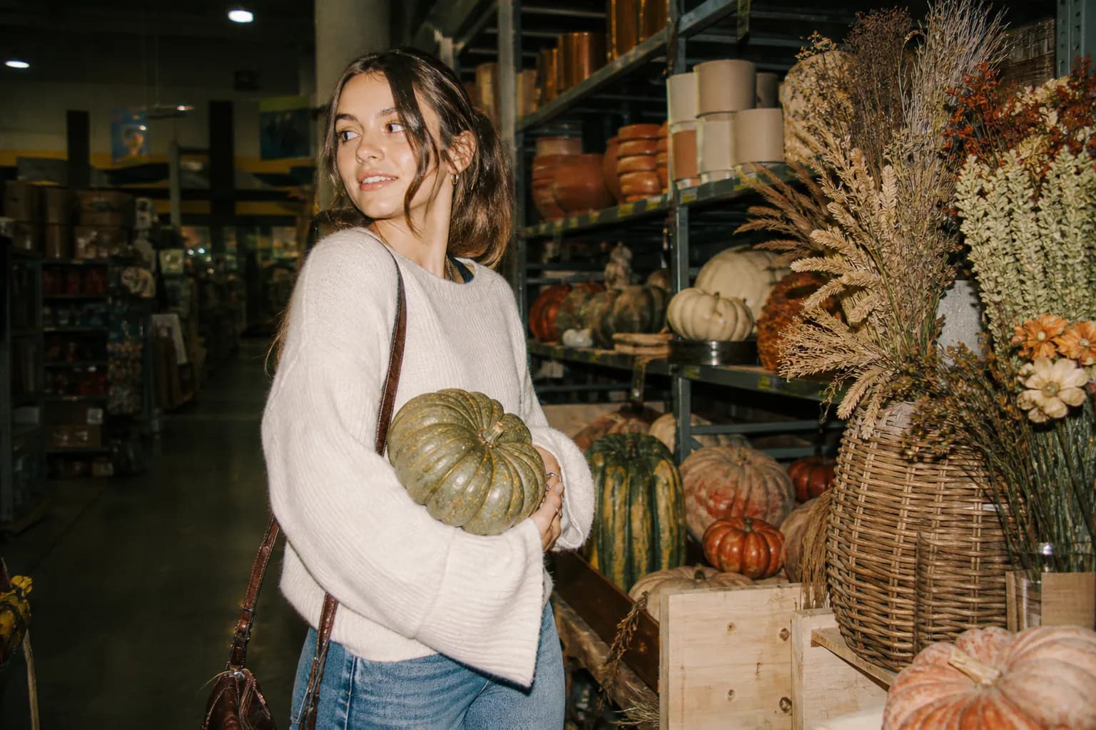 A hardware store aisle decorated with seasonal displays and warm lighting
