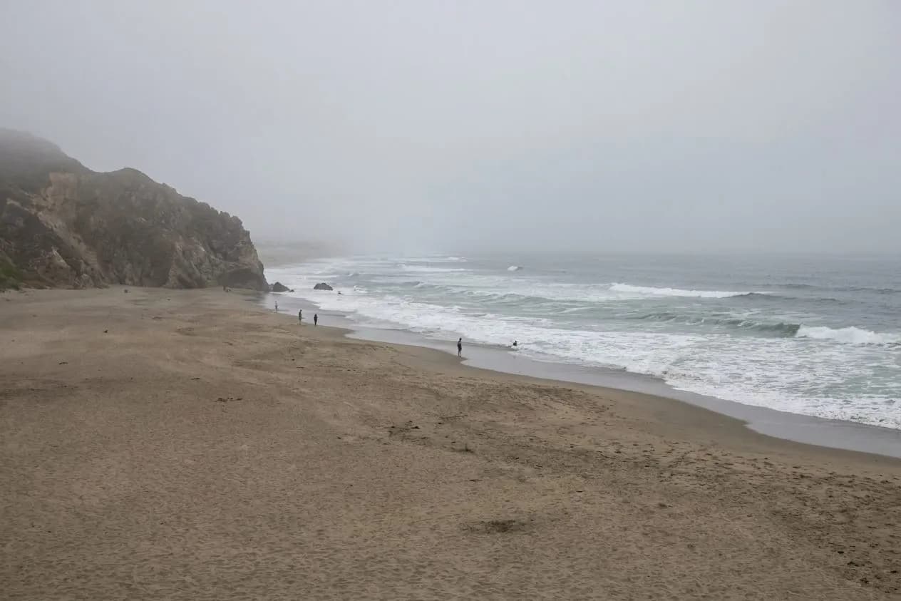 Wide view of Ocean Beach in San Francisco with fog, sand, and waves