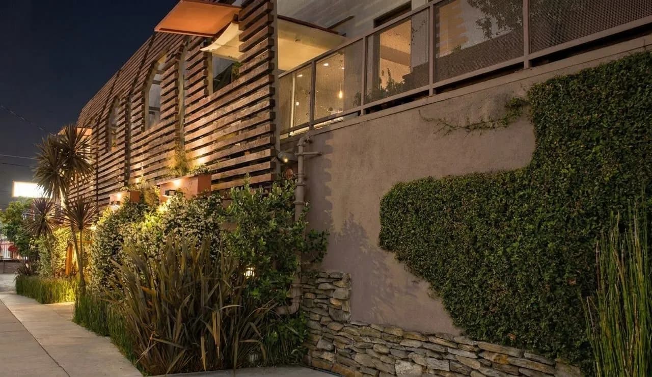 A refined Los Angeles seafood restaurant exterior glowing at night.