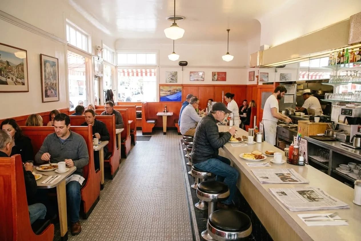Vintage diner counter with chrome stools and red booths