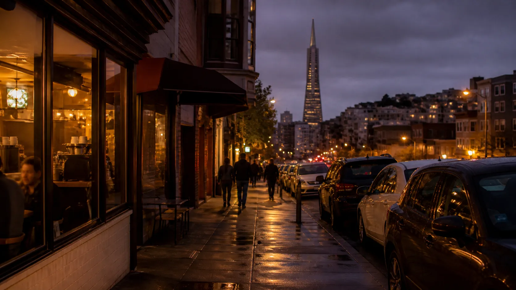 Columbus Avenue in North Beach at night with cafe lights and pedestrians