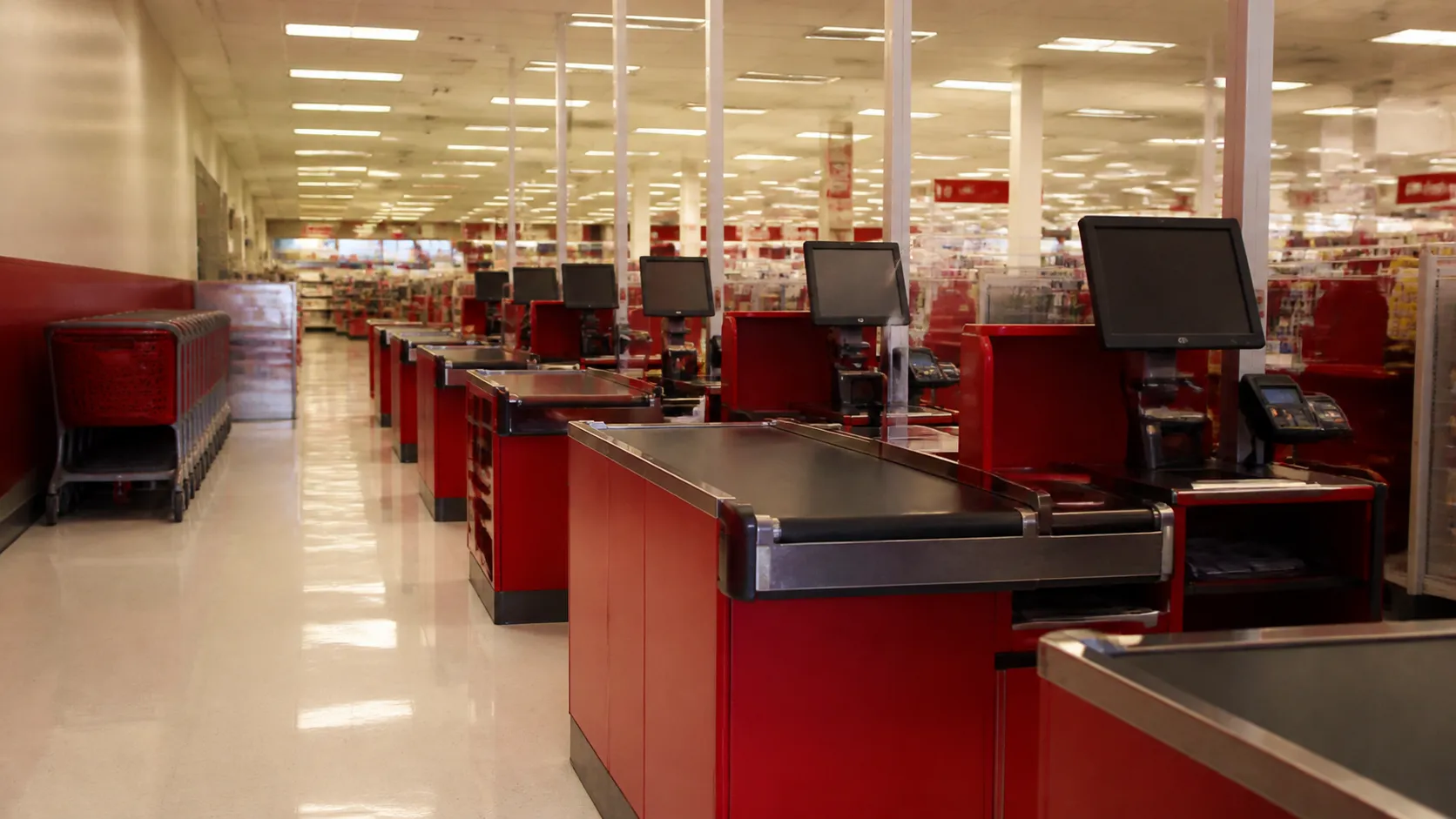 Empty checkout lanes inside a San Francisco Target store with red signage and polished floors
