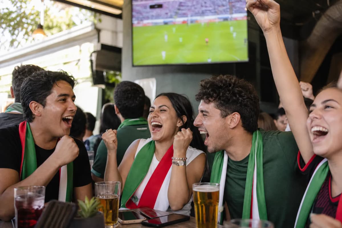 Mexico forward role analysis scene with fans watching a bright match screen