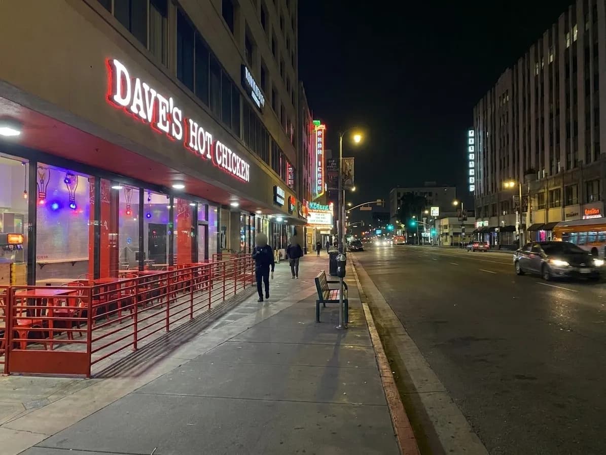 Wilshire Boulevard in Koreatown at night with lit storefronts and street traffic