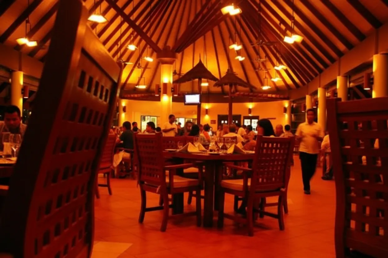 A warm, full restaurant dining room during evening service