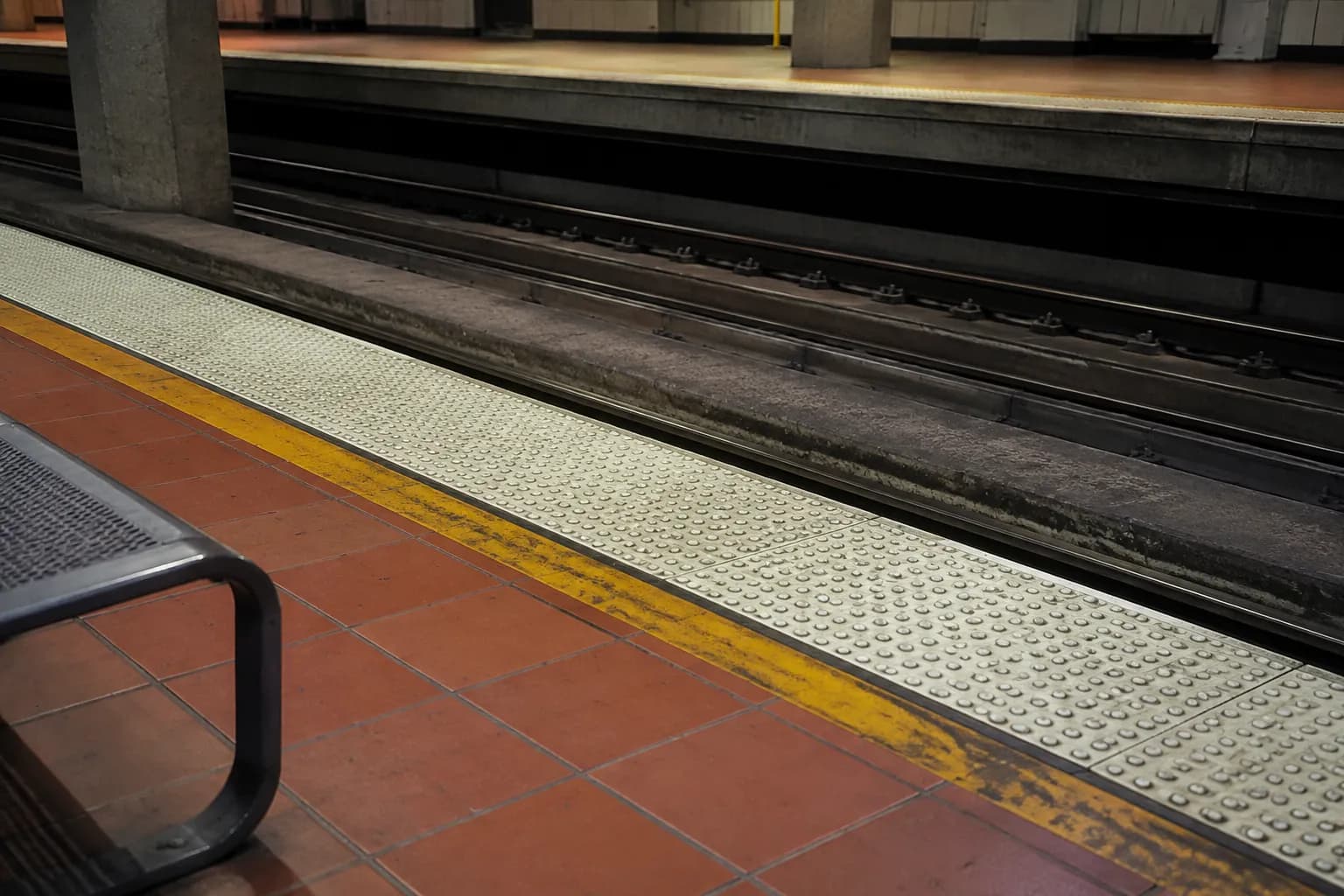 Metro Rail platform detail showing tactile warning strip and track at a Los Angeles station