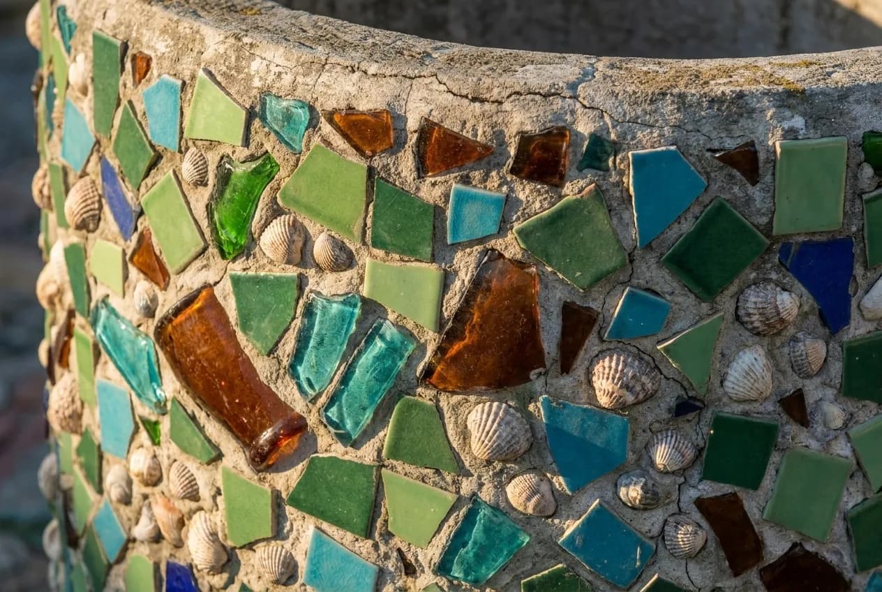 Close detail of mortar studded with broken tile, glass and shells