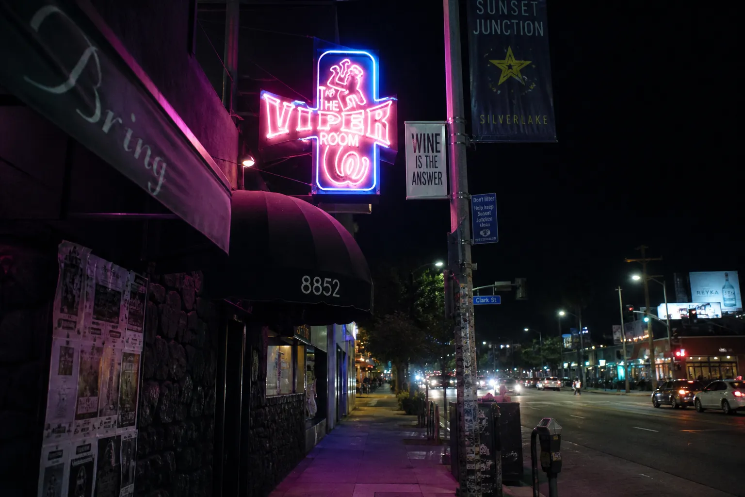Vibrant neon signs illuminating a street corner at Sunset Junction in Silver Lake at night.