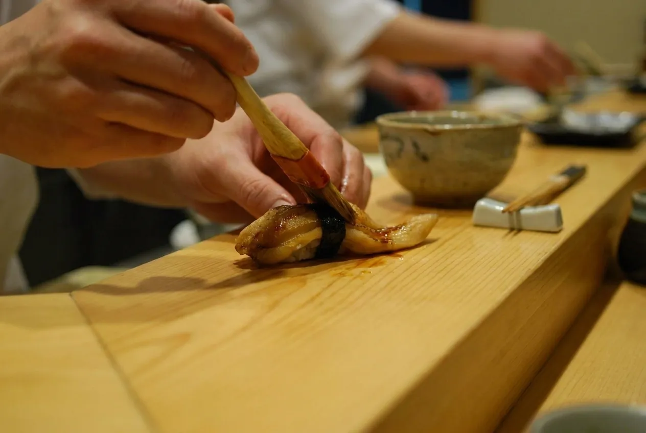 A wooden counter at close range, one course being finished by hand