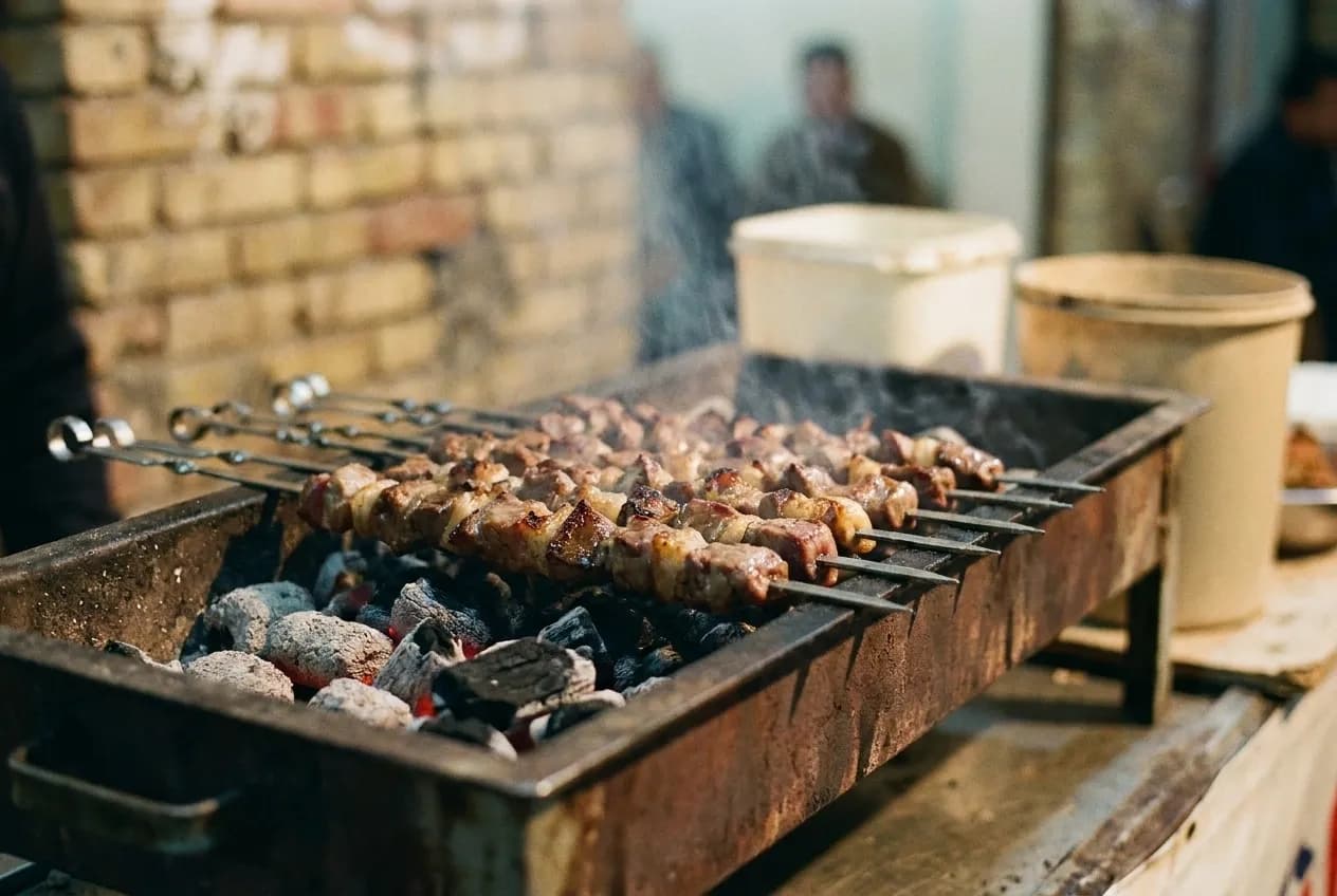 Skewers over charcoal at close range, the edges just taking colour