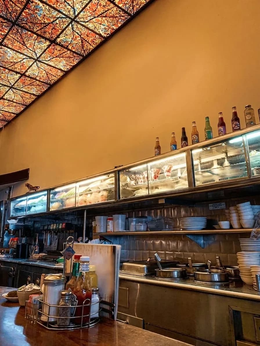 A classic late-night deli booth with mirrored counter seating.