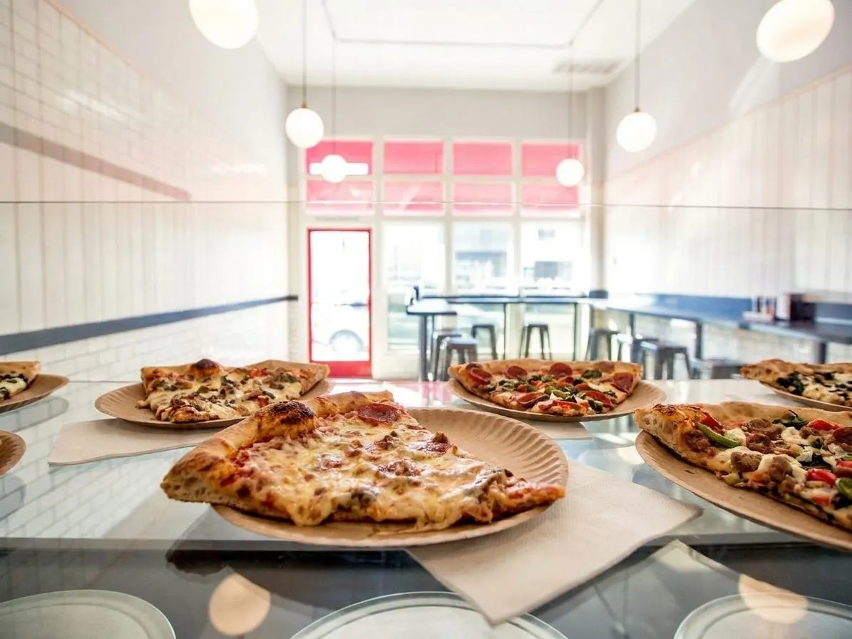 A close-up of LA-style pizza slices on a simple table