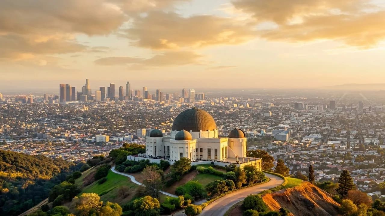 Wide view of Griffith Observatory with Los Angeles spreading below at golden hour
