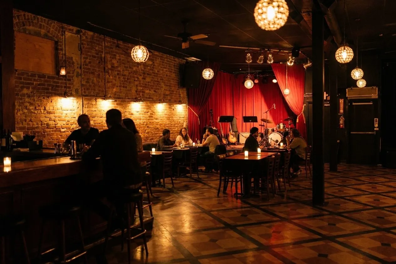 Intimate Hollywood music room with a small stage and bar counter